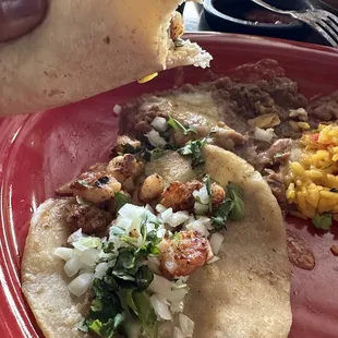 Shrimp street tacos with two corn tortillas.