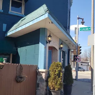 a blue building with a red umbrella