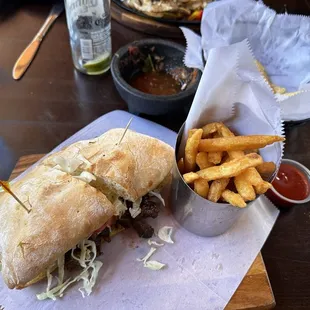 Another great meal: Carnitas pulled pork with coleslaw sandwich on fresh baked bread with dipped French fries. Excellent salsa and chips.