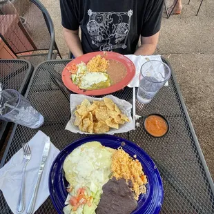 We both got the two enchilada plates. Husband is covered in green sauce, mine is covered in sour cream sauce.