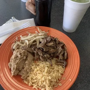 a plate of food with rice and meat