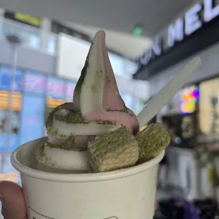Swirl ice cream with strawberry and vanilla, topped with matcha powder and included wafers