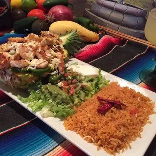 Piña Rellena: grilled juicy chicken, fresh shrimp, sweet pineapple and veggies. Topped with shredded cheese in a pineapple!!!