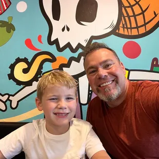 a man and a boy sitting at a table