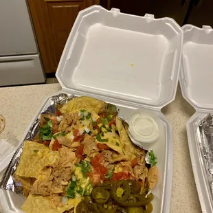 Chicken nachos, sour cream on the side.