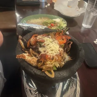 Molcajete - shrimp, beef, and chicken served with rice, beans and tortillas