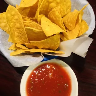 a bowl of chips and a bowl of salsa