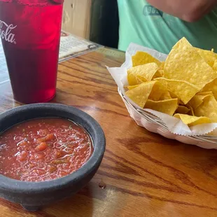 a bowl of chips and a bowl of salsa