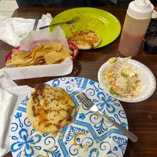 pupusas, cabbage, salsa, chips and bean dip