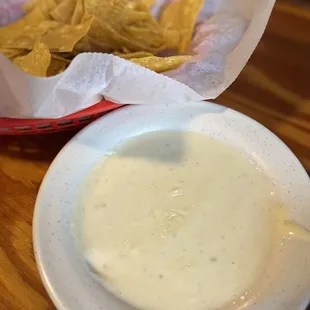 a bowl of quesadilla and a basket of chips