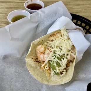 a taco with shrimp and cheese