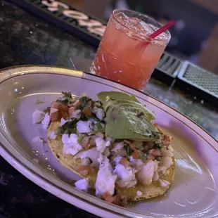 Shrimp tostada and drink at the bar