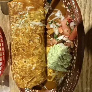 Carne asada burrito with red sauce added on it