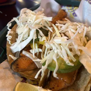 Salmon taco  with  avocado and mango  and shredded cabbage