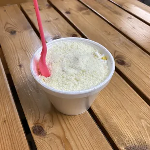 a plastic cup with a pink straw