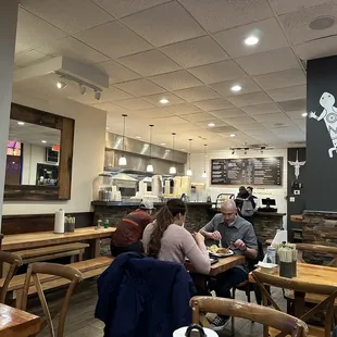 people sitting at tables in a restaurant