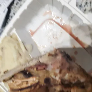 a half eaten meal in a styrofoam container