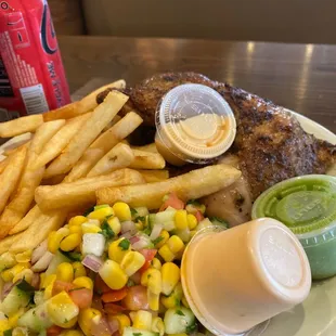 a plate of food with french fries and a salad