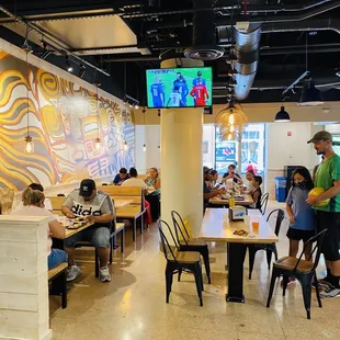 people sitting at tables in a restaurant