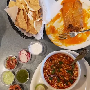 Pozole soup, chicken taco, chicken tamale, chios and some items from the salsa bar.