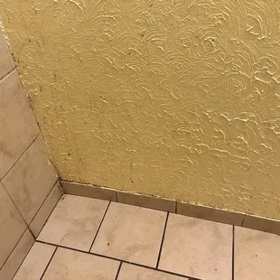 Splatter stains on the wall and baseboard