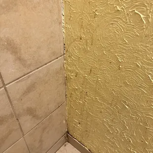 Splatter stains on the wall and baseboard.