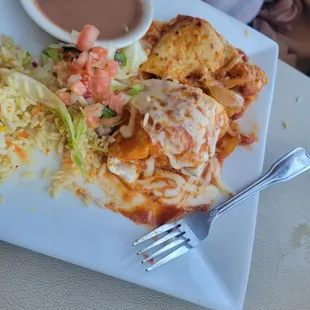 a plate of mexican food with rice and salsa