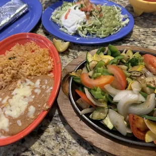 So much food! Veggie fajitas came with tortillas (expected), rice, beans, and guacamole salad!