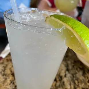 a close up of a drink with a slice of lime