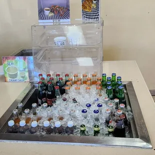 a cooler filled with bottles of soda