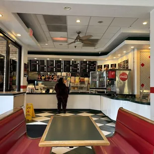  a woman standing at the counter