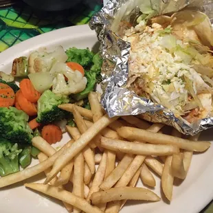 a plate of food with french fries and vegetables