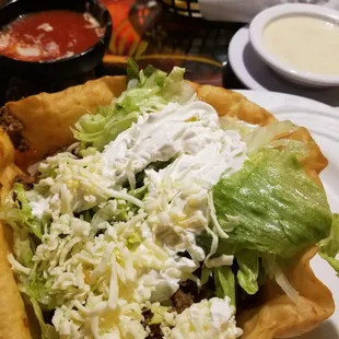 a taco salad with lettuce and cheese