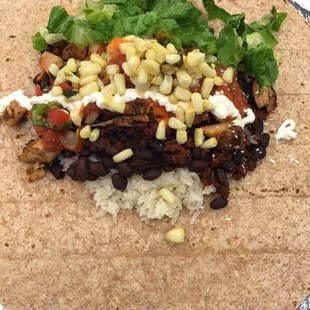 Chicken/Chorizo, black beans/white rice, fire/pico de gallo, lettuce/sour cream .. rolled up in a wheat tortilla.
