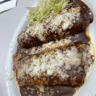 Cheese and beef enchiladas à la cart with lettuce
