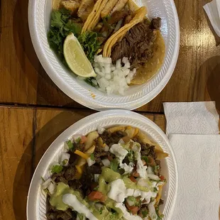 Chicken tacos, and a barbacoa taco, carne asada fries