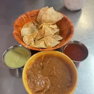  a bowl of chips and a bowl of salsa