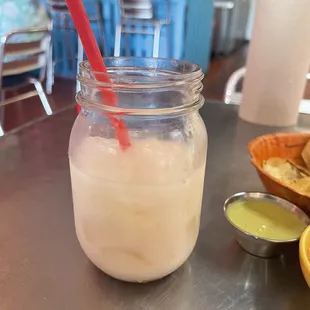  a drink in a jar with a red straw