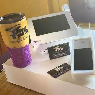 a coffee cup, cell phone, and other items on a table