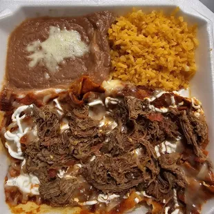 Chilaquiles with machaca with refried beans and rice.