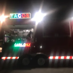 a truck with a neon sign