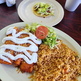 2 ground beef enchiladas, 1 shredded chicken enchilada and double rice. Extra taco on the side