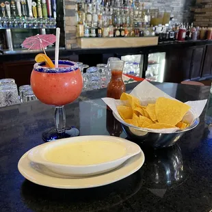 Queso, chips, and Frozen Strawberry Margarita  view from the bar