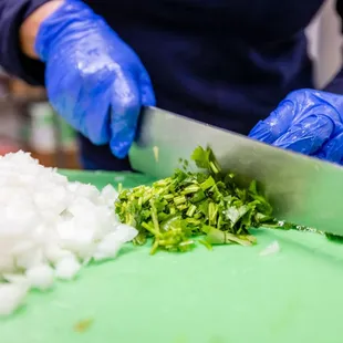 a person chopping onions on a cutting board