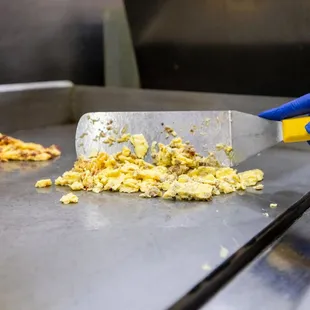 a person in blue gloves cutting food
