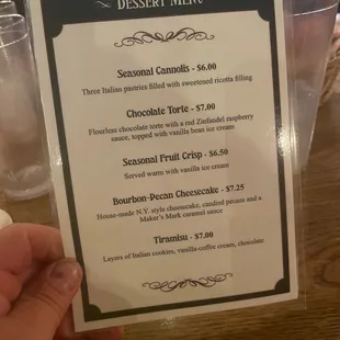a hand holding a menu