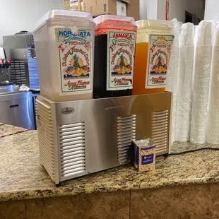 a counter top with a beverage dispenser
