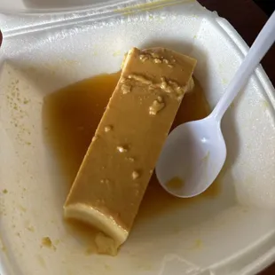 a tofu in a container with a spoon