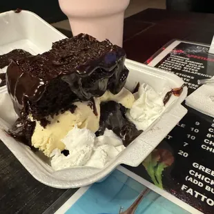 a chocolate cake with ice cream and chocolate sauce
