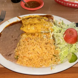 Ground beef, enchiladas with rice and beans and a salad